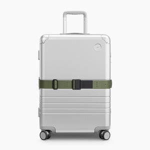 Olive Green | Front view of Aluminum suitcase with the Olive Green Luggage Strap secured around it