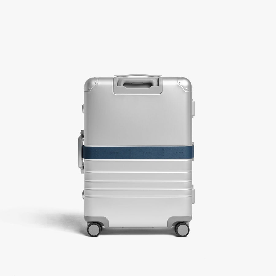 Ocean Blue | Back view of Aluminum suitcase with the Ocean Blue Luggage Strap secured around it