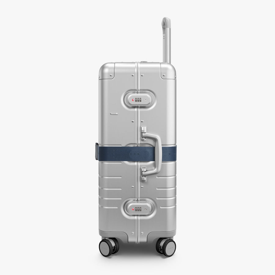 Ocean Blue | Side view of Aluminum suitcase with the Ocean Blue Luggage Strap secured around it