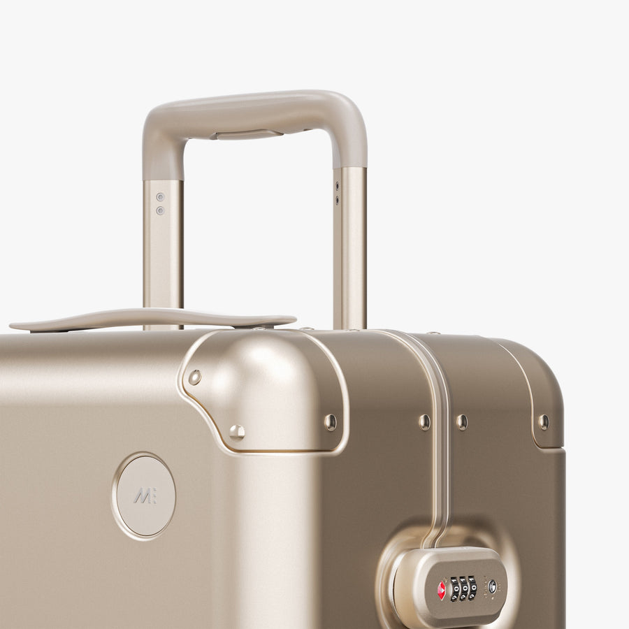 Champagne Gold | Luggage handle view of Aluminum Check-In Medium in Champagne Gold