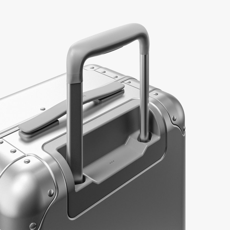 Aspen Silver | Extended luggage handle view of Aluminum Carry-On Plus in Aspen Silver