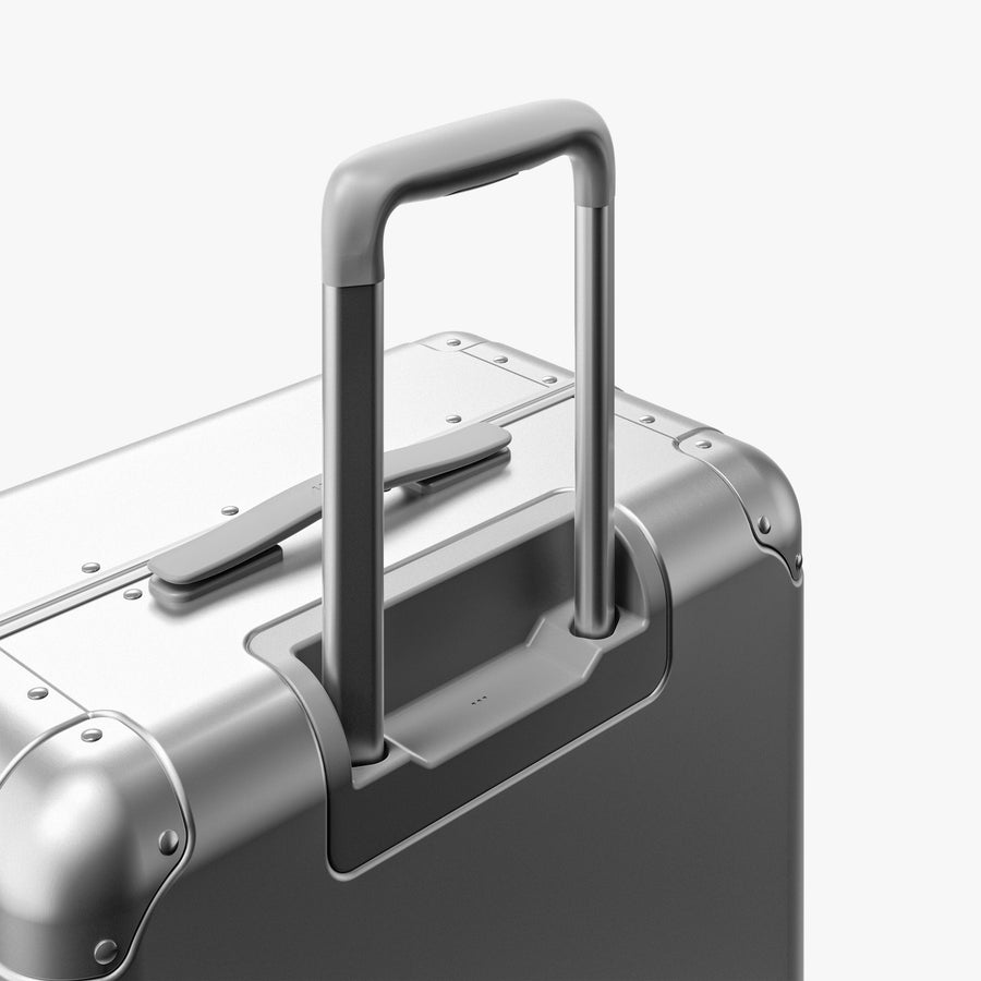 Aspen Silver | Extended luggage handle view of Aluminum Check-In Medium in Aspen Silver