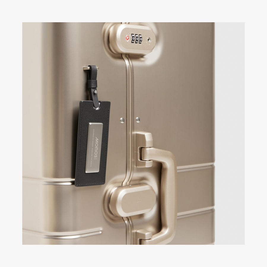 Champagne Gold | Luggage tag view of Aluminum Trunk in Champagne Gold