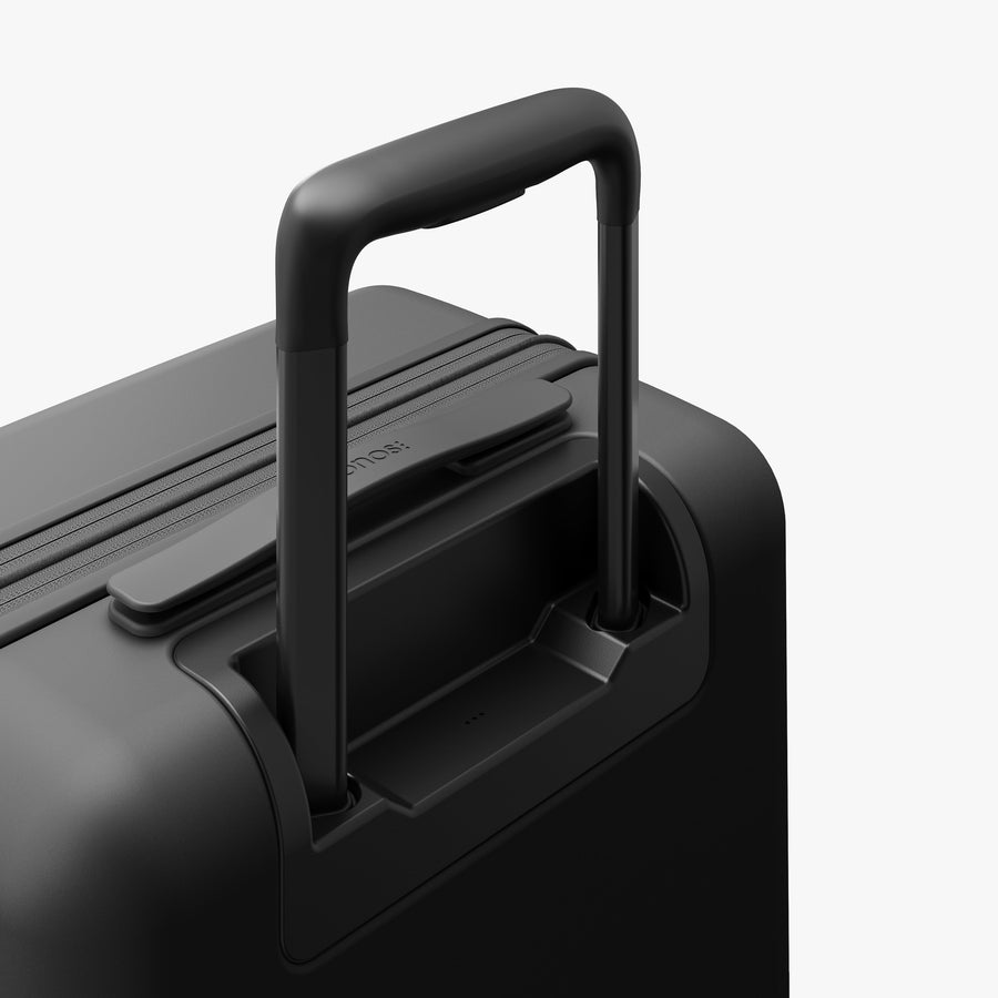 Midnight Black | Extended luggage handle view of Expandable Carry-On Pro in Midnight Black