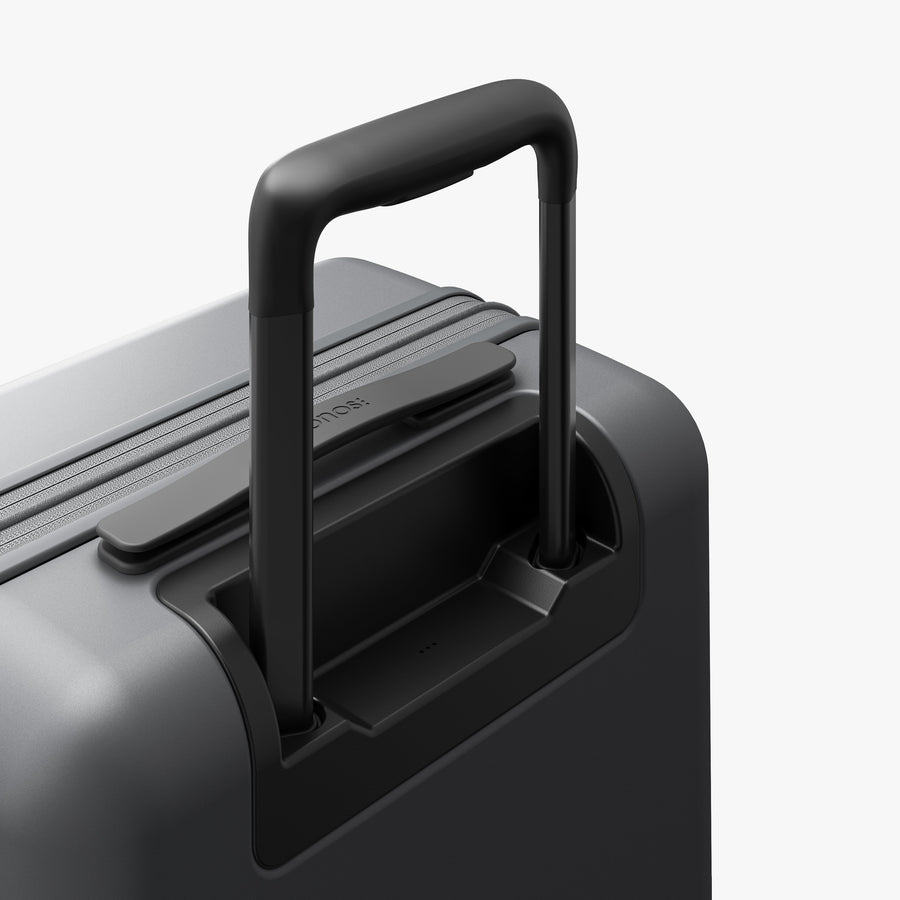 Storm Grey | Extended luggage handle view of Expandable Carry-On Pro in Storm Grey