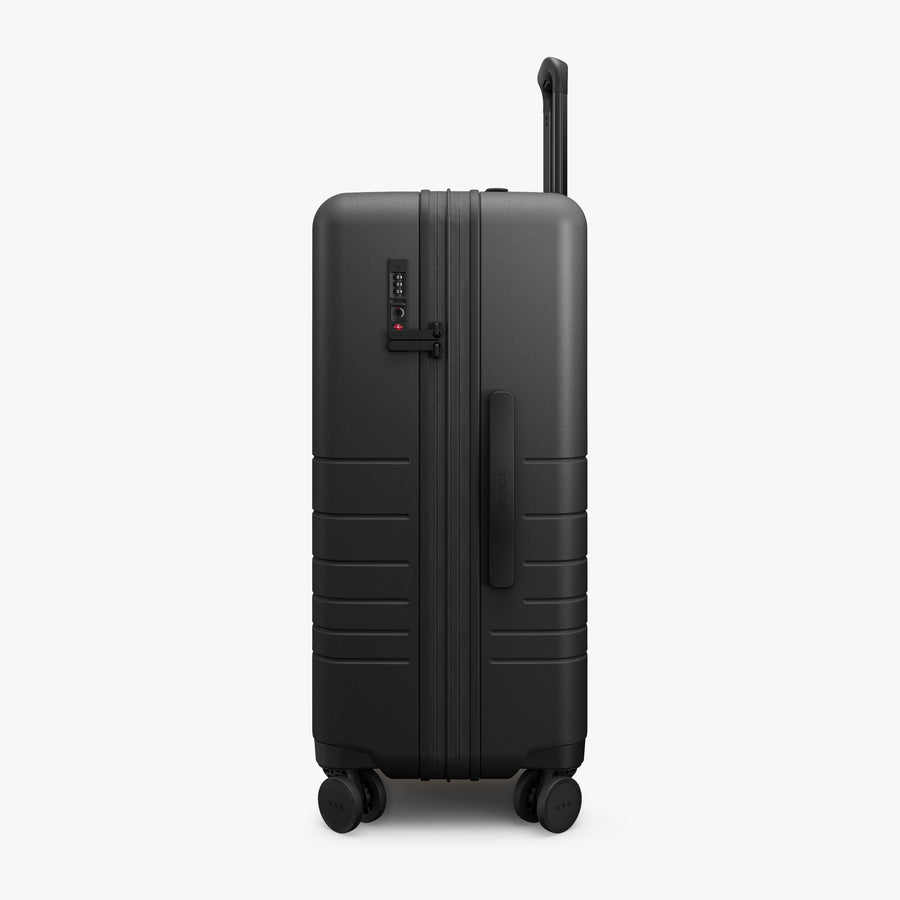 Midnight Black | Side view of Expandable Check-In Medium in Midnight Black