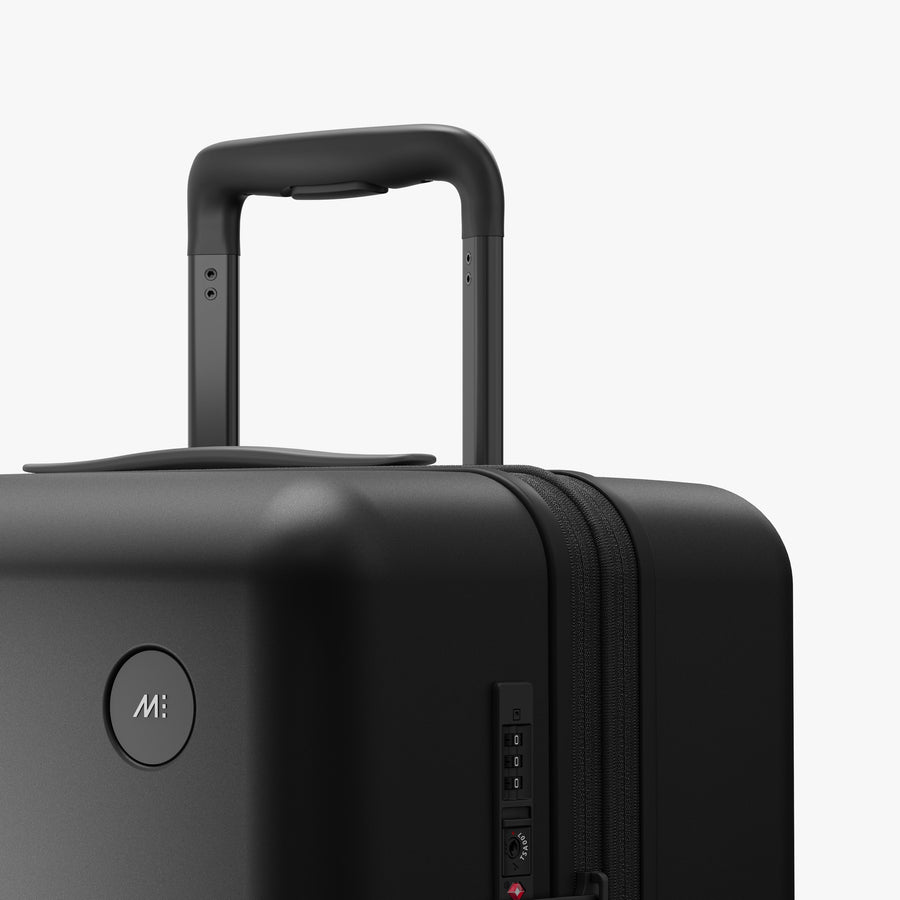Midnight Black | Luggage handle view of Expandable Check-In Medium in Midnight Black