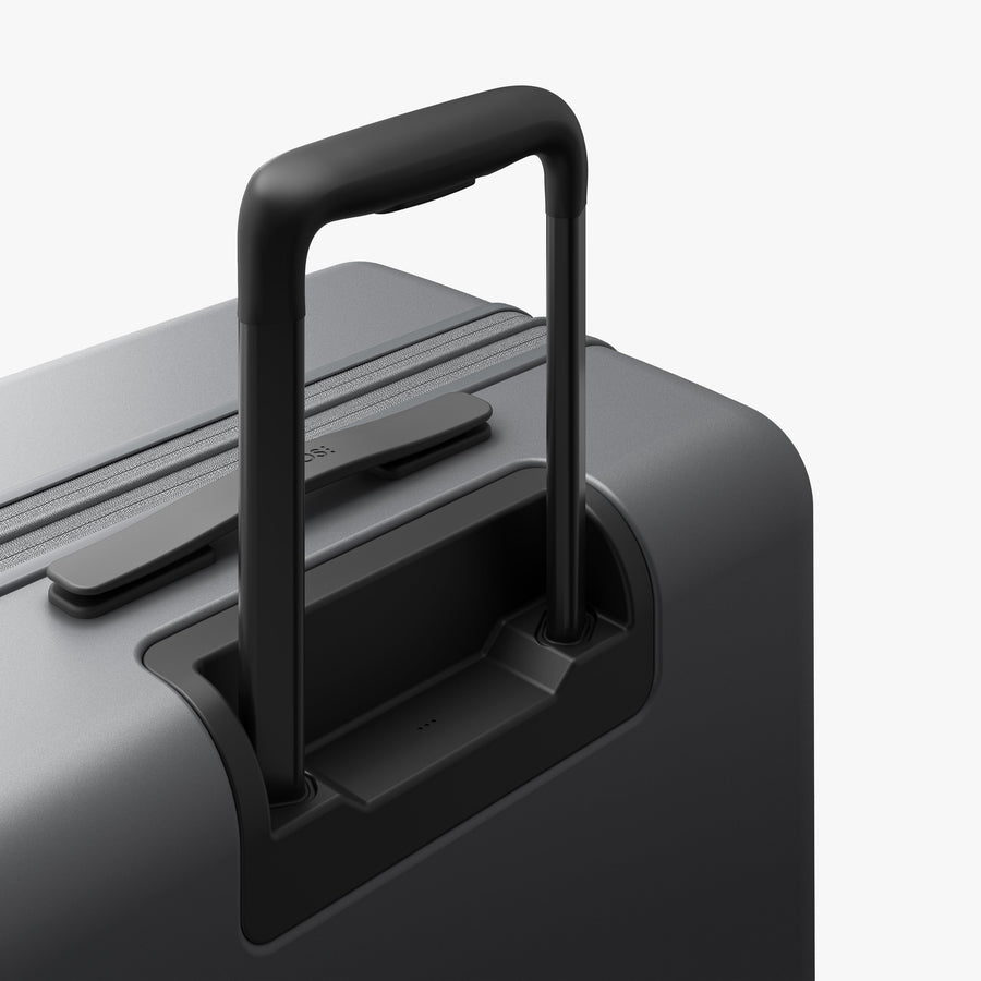 Storm Grey | Extended luggage handle view of Expandable Check-In Medium in Storm Grey