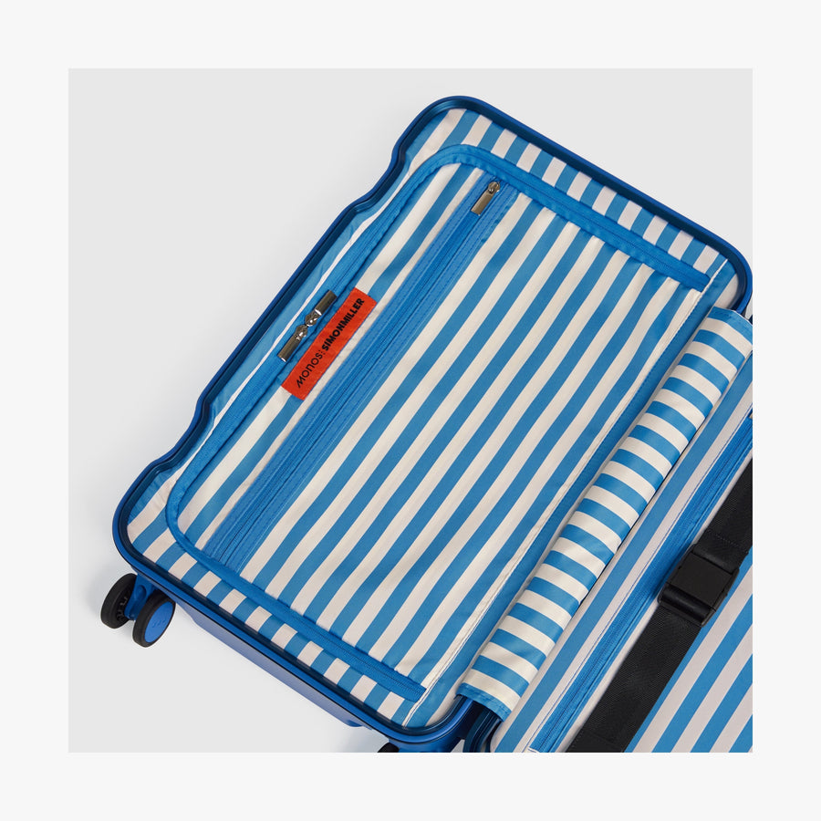 Coastal Blue | Interior view of a Hybrid suitcase in Coastal Blue featuring the Poplin Stripe Coastal Blue zipped compartment