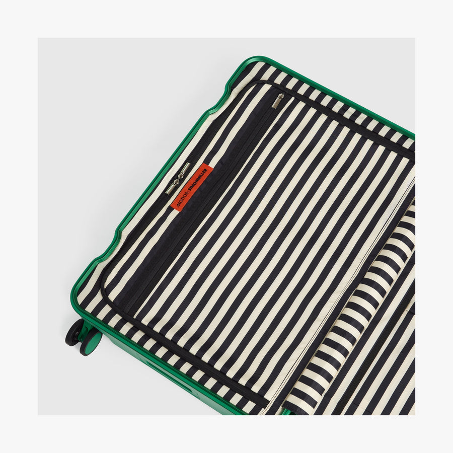 Jungle Green | Interior view of a Hybrid suitcase in Jungle Green featuring the Poplin Stripe Jungle Green zipped compartment
