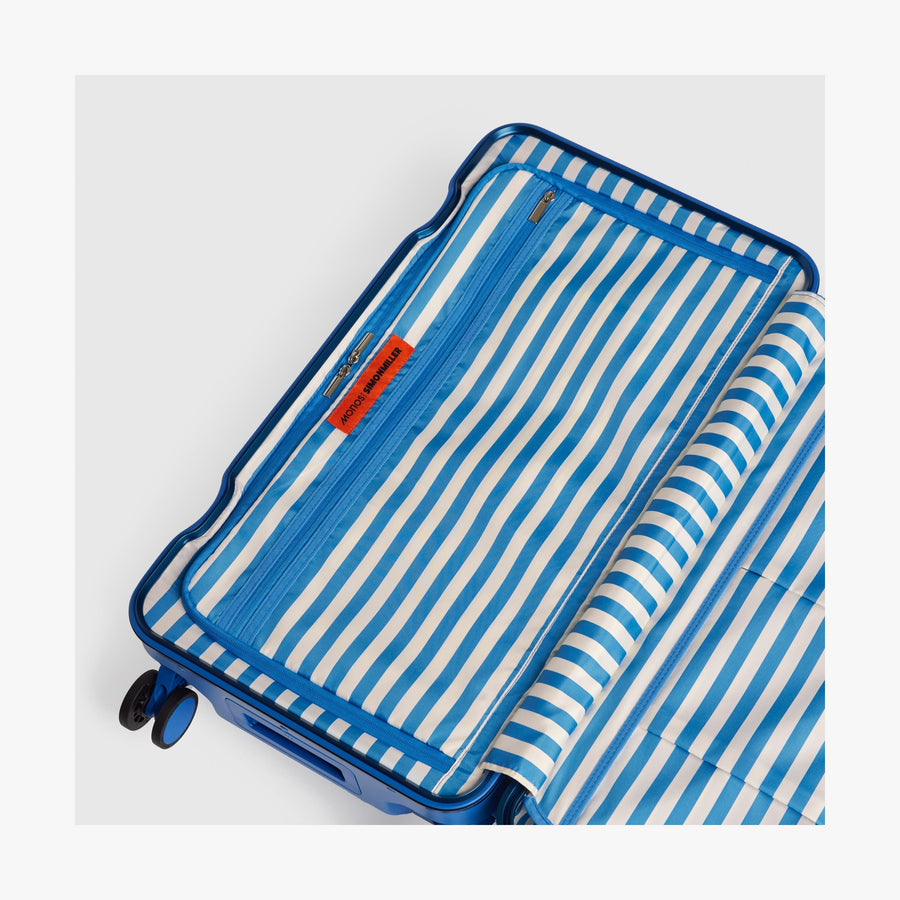 Coastal Blue | Interior view of a Hybrid suitcase in Coastal Blue featuring the Poplin Stripe Coastal Blue zipped compartment