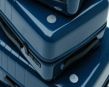 The Monos Classic Luggage in Arles Blue Glossy — a sleek, reflective finish that highlights the timeless curves of the Classic collection.