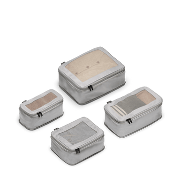 This is a photo of a set of four compressible packing cubes in grey