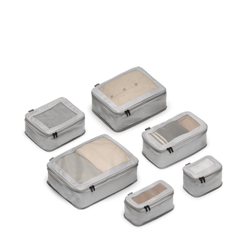 This is a photo of a set of six compressible packing cubes in grey