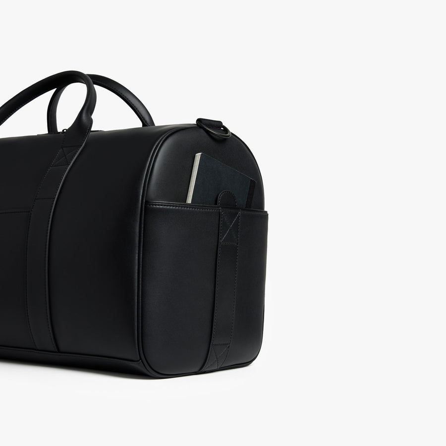 Carbon Black (Vegan Leather) | Angled view of Metro Carry-All Duffel in Carbon Black
