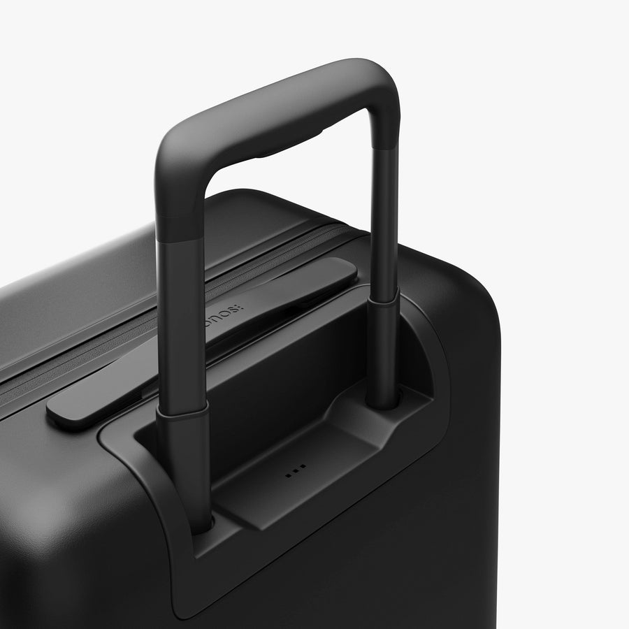 Midnight Black | Extended luggage handle view of Carry-On in Midnight Black