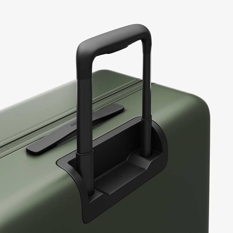 Olive Green | Extended luggage handle view of Check-In Large in Olive Green