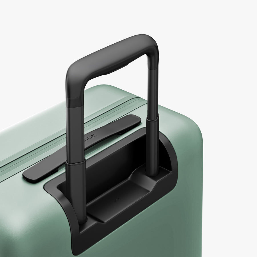 Sage Green | Extended luggage handle view of Carry-On Plus in Sage Green